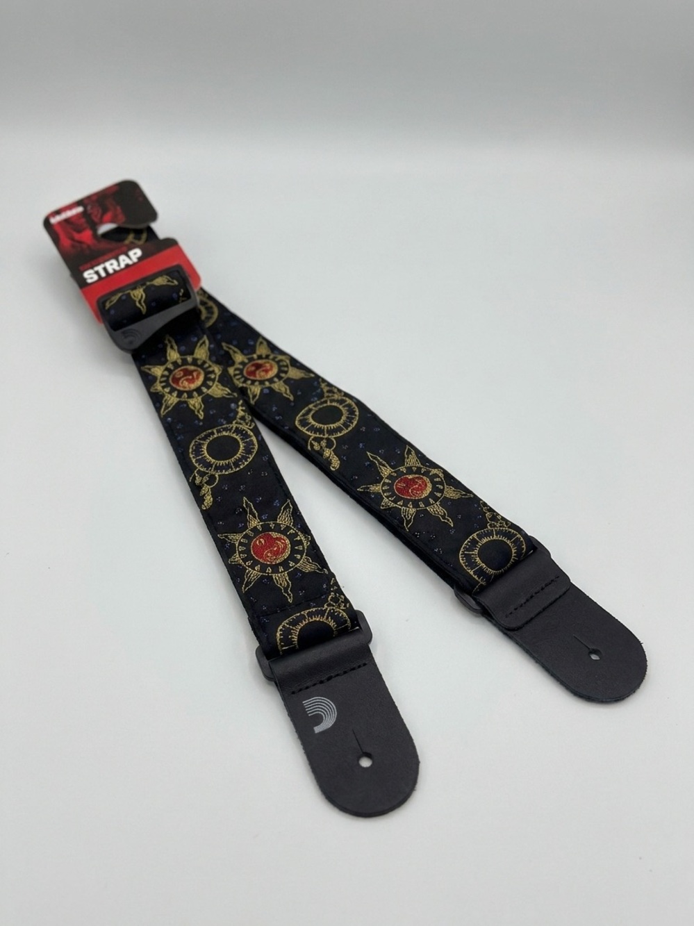 D'Addario 50 mm Nylon Guitar Strap featuring a gold and red Sun and Moon design